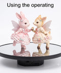 JAYEGT Motorized Rotating Display Stand, 10-Inch Mirror Finish Turntable showcasing figurines on a sleek black base.