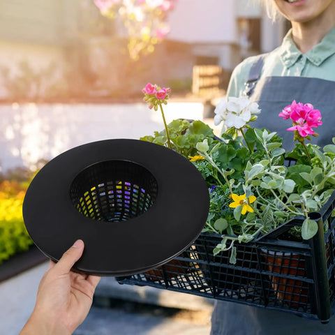 Person holding durable hydroponic mesh net pot bucket with high drainage in a garden setup with colorful flowers