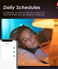 Woman using phone to schedule Edison ST19 ST64 WiFi LED Smart Bulb with app for lighting control, lamp beside her bed.