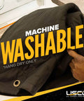 Man placing Oversized 80 By 72 Inches Sound Dampening Blanket For Studios And Wall Hanging With Grommets into a washing machine.