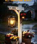 2 Pack Solar Lanterns Outdoor Waterproof Hanging Lights illuminating mailbox post with flowers in rain
