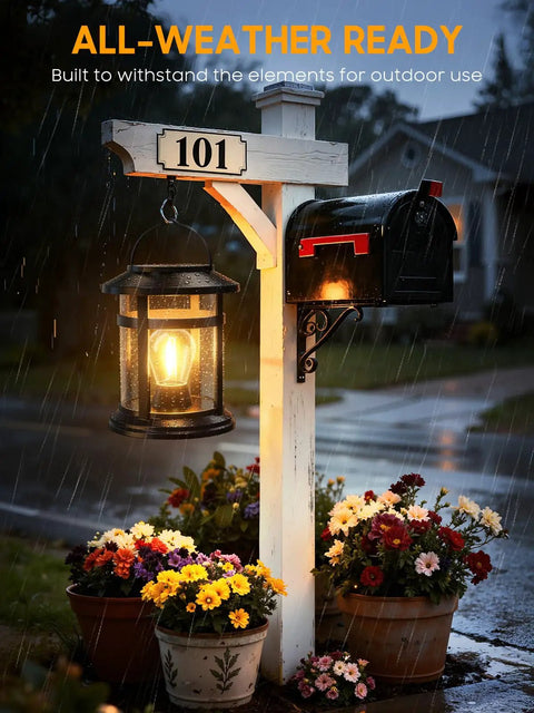 2 Pack Solar Lanterns Outdoor Waterproof Hanging Lights illuminating mailbox post with flowers in rain