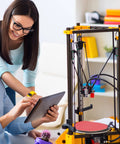 Person using tablet next to 3D printer with 31.5 Inch 2020 Aluminum Extrusion T Slot Rail European Standard Anodized Black Linear Rail