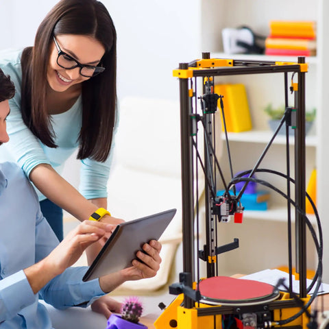 People using a tablet near a 3D printer with a frame made from Four Piece 39.3 Inch 2020 Aluminum Extrusion With T Slot Rail European Standard Anodized Black