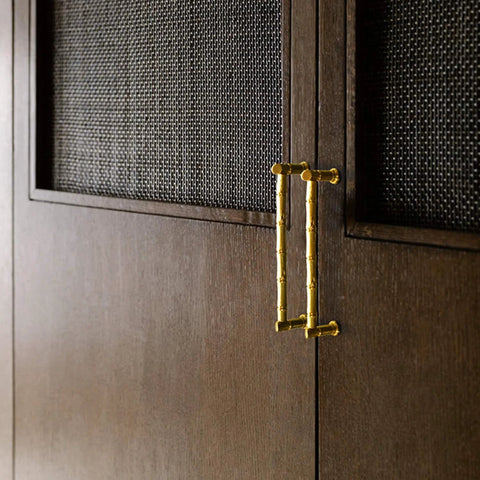 Gold Brass Bamboo Shape Cabinet Handles Set, Antique Brushed Copper Finish, installed on wooden cabinet doors.