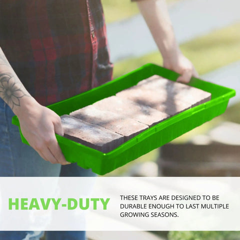 Person holding Beast Mode Durable Seed Starting Trays For Seedlings And Microgreens with bricks inside, showing tray strength