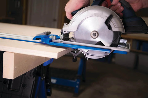 Side view of Two Track Clamps With Non Slip Grip For Track Saws, installed on T Slot Tracks, holding a saw on wood, Model KMA7520.