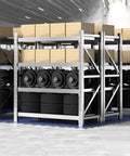 Rock Solid Heavy Duty Garage Shelving Four Tier Commercial Steel Storage Rack Industrial Grade Metal Organizer For Home Pantry Kitchen And Workshop With Heavy Gauge Steel Construction And Cross Bracing storing tires and boxes.