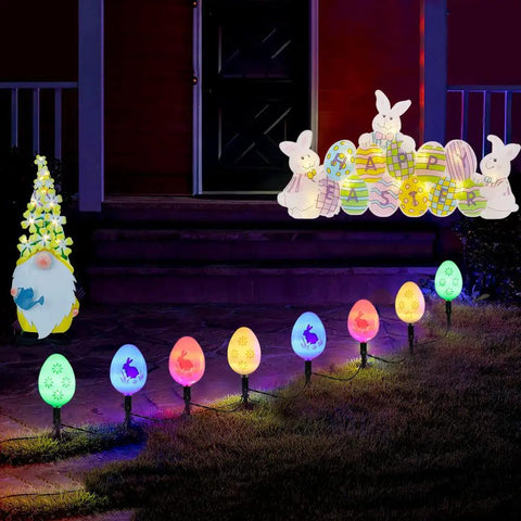 Night view of 20 LED Solar Easter Egg Lights Outdoor Stake With 25 Ft Cord, 8 Modes Waterproof Yard Pathway Garden Lights illuminating a pathway.