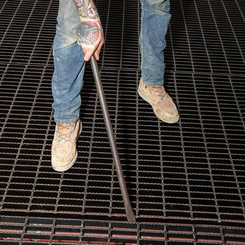 Worker using Ergonomic Round Connecting Bar 7/8 Inch Wide By 30 Inch Long With 15 Degree Angled Chisel, Tapered End