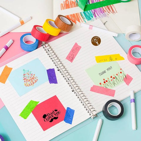 Open creative journal with Rainbow Masking Tape Set With Twelve Rolls Of Colorful Painter Tape One Inch By Seven Hundred Twenty Feet Each, vibrant craft tape decorating the pages.