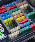 Assorted fuses in a box including Dope 75 Pack 15 Amp Mini Car Blade Fuses For Cars RVs Trucks SUVs Motorcycles and Boats 32V