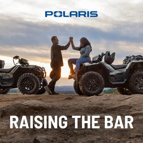 Two people high-fiving near SPORTSMAN ATVs at sunset, promoting CVT Drive Belt Replacement For Select SPORTSMAN ATV Models 3211160.