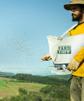 Person using Shoulder Seeder And Grass Seed Spreader With 25 Pound Capacity All Metal Gears Durable Canvas Bag Adjustable Shoulder Strap