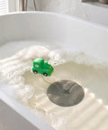 TEHAUX Silicone Bathtub Drain Stopper 15cm, Hair Catcher for Bathroom with green toy truck in bubbly water.