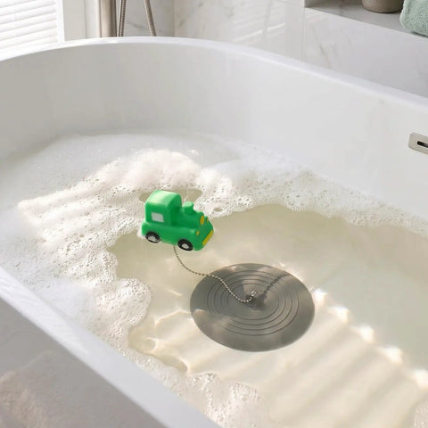 TEHAUX Silicone Bathtub Drain Stopper 15cm, Hair Catcher for Bathroom with green toy truck in bubbly water.