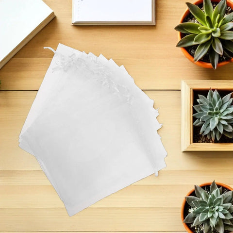 White Organza Drawstring Favor Bags Pack Of 100 Reusable Mesh Pouches on wooden table with succulents