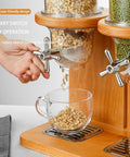 Rock Solid Three Barrel Grain Dispenser For The Kitchen Counter With Smooth Pour Valves And Sturdy Sapelli Wood Base Holds 12 Liters Of Coffee Beans Or Snacks A Total Game Changer For Mess Free Pantry Storage with oats dispensing into a glass cup.