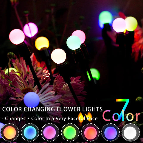 Colorful bulbs of Solar Garden Lights With Starburst Swaying Motion Wind Powered RGB Outdoor Lights set in a dark garden