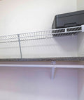 Heavy Duty Wire Shelf Support Brackets Kit For Closets Featuring Solid Metal Bars Wire Shelving Clips Corner Mounts And Screws mounted in wall above a grey countertop.