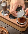 Hands using Wooden Tamping Station For Espresso Anti Slip Tamper Stand And Portafilter Organizer Fits 51mm And 54mm Portafilters Holds Tamper