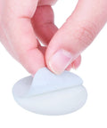 Close-up of a hand peeling the adhesive backing from a white 20 Pack Self Adhesive Door Knob Wall Protector Round Rubber Bumper