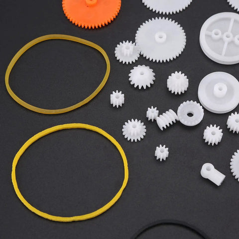 Assorted small gears and belts from 78 Piece Plastic Gears Kit With Pulleys Belts Racks And Axles For DIY Projects and Repair