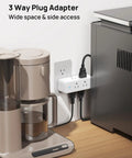 Real Deal Six Port Outlet Extender Surge Protector With Manual Switch And 360 Swivel Head To Easily Upgrade Any Wall Jack While Cutting Cord Chaos And Making Daily Power Ups Super Breezy For Busy Households, 3 way plug adapter beside coffee maker.