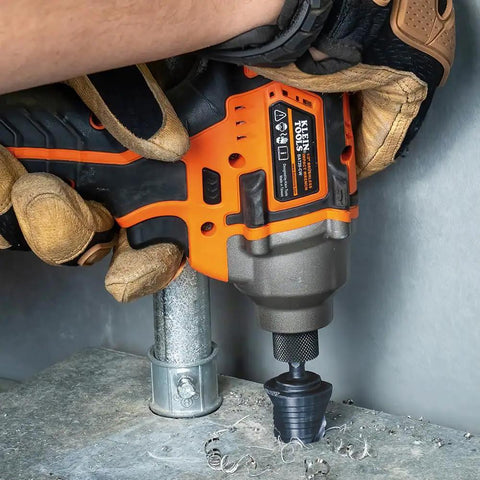 Heavy Duty Step Drill Bit With Quick Release Spiral Flutes And Hex Shank cuts steel wood plastic aluminum effortlessly in the seven eighth to one eight inch range durable nitride coating so it never gets slammed works like a champ for impact drivers, user holding drill.