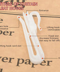 Close-up of white hook from 80 Pack Plastic Curtain Hooks With Adjustable Pinch Pleat Ratchet System on paper background.