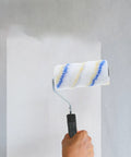 Top Shelf Three Piece Paint Roller Brush Set With Comfort Grip Handle And Ultra Soft Protective Bristles painting a wall.