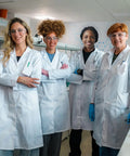 Group of adults wearing Unisex White Lab Coat For Adults With Long Sleeves, Stain Resistant Polyester, in a laboratory setting