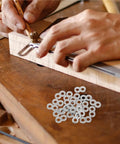 Craftsman using Top Notch Figure Eight Tabletop Connectors 180 Pack Stainless Steel for furniture assembly on wood.