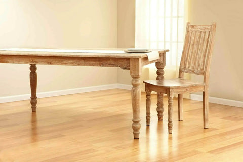 Top Shelf Felt Furniture Protectors For Hardwood Floors Beige Self Stick Pads under wooden table and chair in empty room.