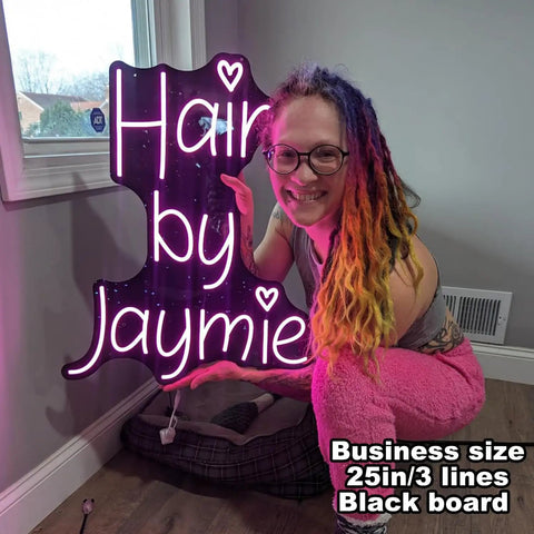 Woman holding personalized neon LED sign for weddings and events, battery or plug operated lit up name logo for home wall decor.