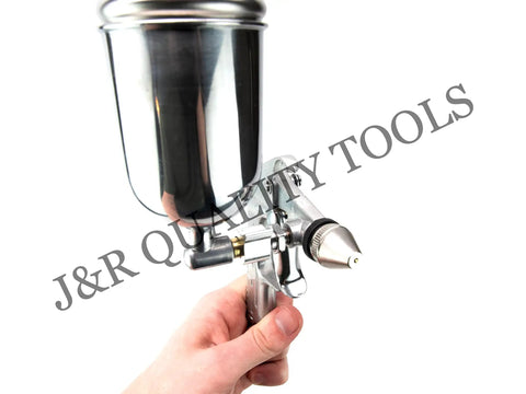 Slick Compact Spray Gun Airbrush Kit With A Hella Precise 0.5mm Nozzle held in hand for fine detail painting.