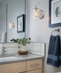 Kira Home Rayne 10" Modern Farmhouse Wall Sconce for Bathroom Vanity, Pack of 2 with brushed nickel finish and clear glass shade.
