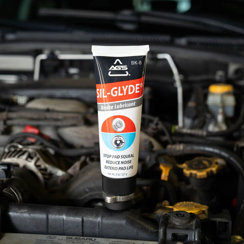 SIL Glyde Brake Lubricant High Temp Formula 8 Oz Tube in engine bay, showing caliper grease for heat resistance and rust protection.