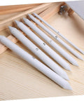 Two Piece Set Of Pro Drawing Stumps For Sketching And Blending, Paper Stumps For Graphite And Pastel arranged on a wooden surface