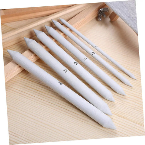 Two Piece Set Of Pro Drawing Stumps For Sketching And Blending, Paper Stumps For Graphite And Pastel arranged on a wooden surface