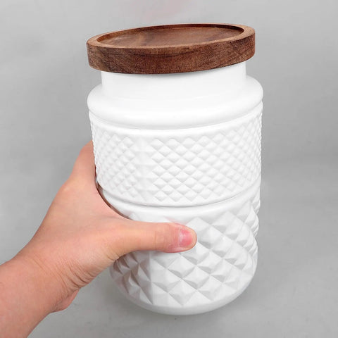 Premium Glass Canisters With Airtight Wood Lids And Wide Mouth Opening Perfect For Storing Coffee Beans Grains Cereal Spice Jars To Level Up Your Kitchen Pantry Vibes Dope Food Storage Set Of Two held in hand.
