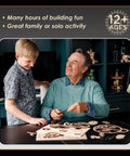 Grandfather and grandson assembling 3D Wooden Gear Clock Kit For Teens And Adults, mechanical clock parts spread on table.