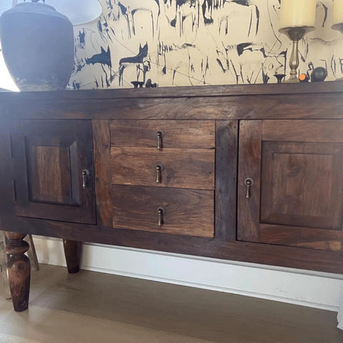 Antique Bronze Single Hole Cabinet Pull For Wooden Furniture Cabinets Cupboards Drawers Wardrobes Doors 62x24mm 2.44x0.94 Inches Durable Zinc Alloy Handle Rust Resistant Vintage Style Hardware For Home Renovation installed on a wooden cabinet with decorative wallpaper.