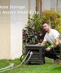 Man using Heavy Duty Steel Garden Hose Reel Deck Box Holds 125 Ft Of 5/8 Inch Hose With Leak Proof Aluminum Water System outdoors.