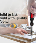 Hand using Six In One Screwdriver Set Grab And Go with Non Slip Grip for multipurpose use on wooden panel.