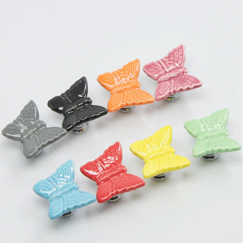 Multicolored ceramic butterfly cabinet knobs set, including pink, grey, black, orange, red, yellow, and green