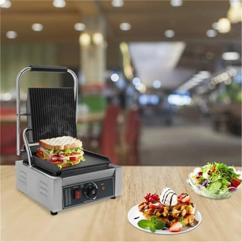 Heavy Duty 1800W Commercial Sandwich Panini Press Grill with sandwich, stainless steel, in a restaurant setting.