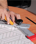 Using Tough As Nails 48 Inch Aluminum Adjustable Drywall T Square Tool with Fast Adjust Head for precise measuring on a table.