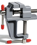 Heavy Duty Cast Iron Bench Vise With 360 Swivel Base Rock Solid Grip For Compact Desk Workholding In Garage Shop Diy Crafts Jewelry Making And Soldering Jobs, grey color, close-up view with red grips.