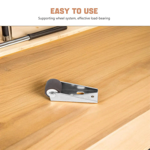 Close-up of Heavy Duty Barn Door Floor Guide With Slick TPE Rubber Caster on wood surface, supporting smooth rolling action.